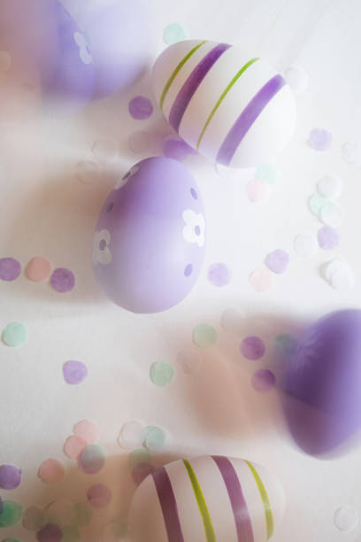 istock painted easter purple eggs with ornament and decor on white light pastel background. motion blur 1369114382