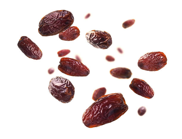 Dried dates levitate on a white background stock photo