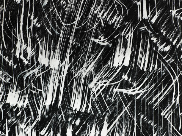istock Patterns of white paint from a brush on a black background 1369115896