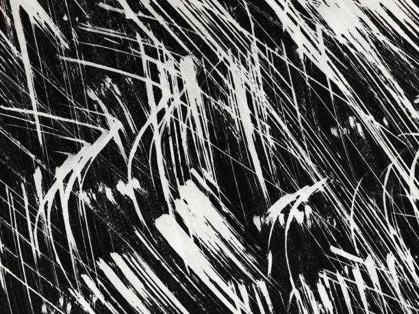 istock Patterns of white paint from a brush on a black background 1369116792