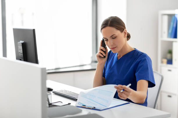 istock doctor with computer calling on phone at hospital 1369117683