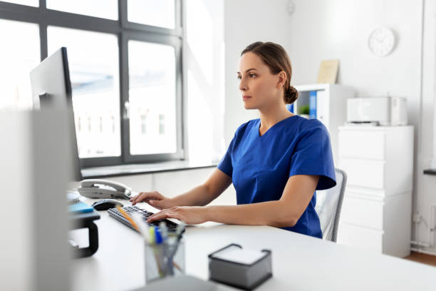 doctor or nurse with computer working at hospital stock photo