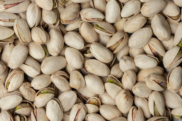 istock Pile of roasted salted pistachios as background 1369118620
