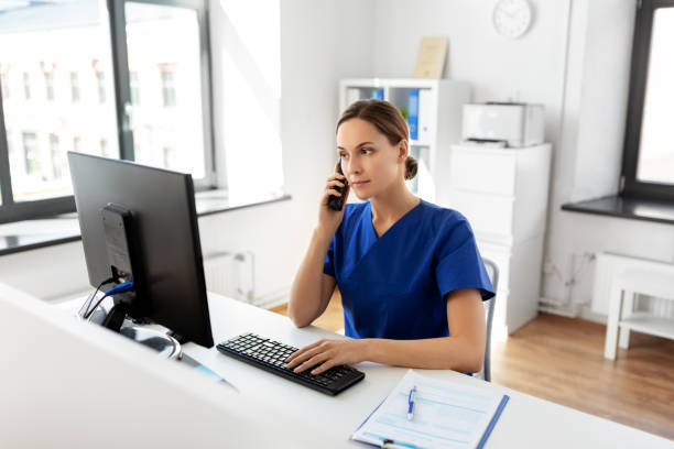 istock doctor with computer calling on phone at hospital 1369118760