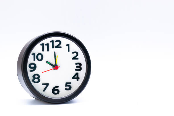 istock Black alarm clock isolated on white background. The clock set at 10 o'clock. 1369118783