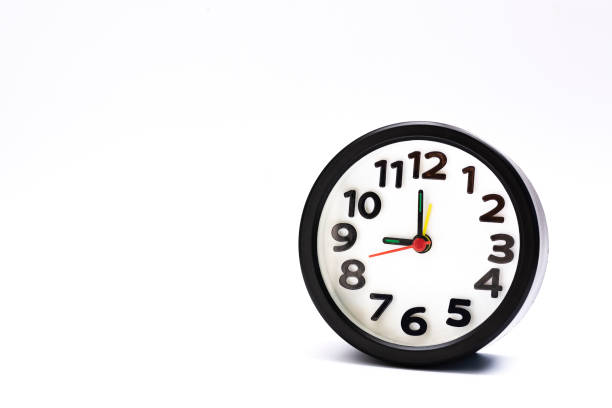 istock Black alarm clock isolated on white background. The clock set at 9 o'clock. 1369118784