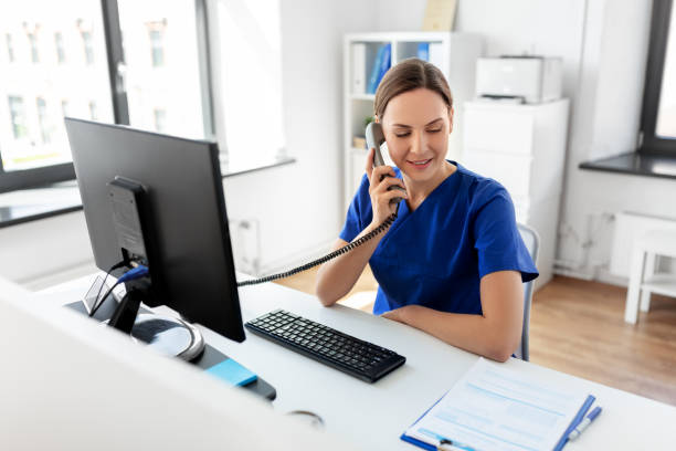 istock doctor with computer calling on phone at hospital 1369118838