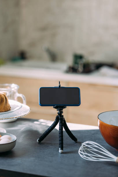 istock Pastry Chef's Vlog: A Smartphone on a Tripod Stand on the Kitchen Countertop 1369119045