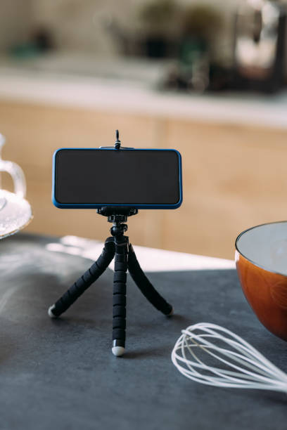istock Pastry Chef's Vlog: A Smartphone on a Tripod Stand on the Kitchen Countertop 1369119048
