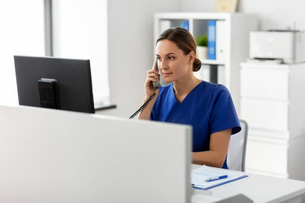 istock doctor with computer calling on phone at hospital 1369119181