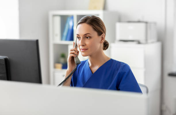 doctor with computer calling on phone at hospital - nurse on phone serious bildbanksfoton och bilder