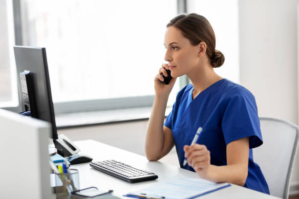 doctor with computer calling on phone at hospital - nurse on phone serious bildbanksfoton och bilder