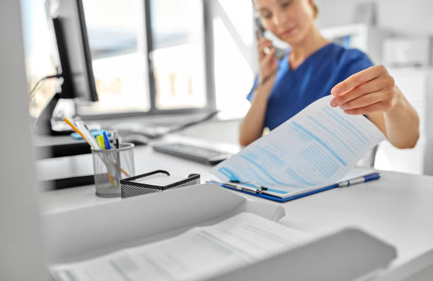 istock doctor with computer calling on phone at hospital 1369119473