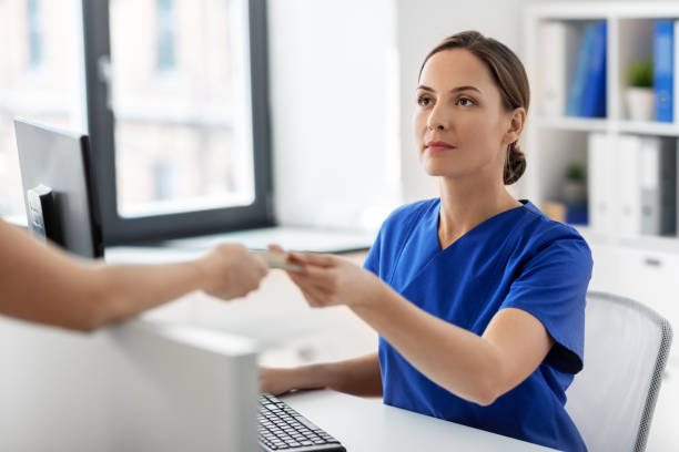 doctor and patient with credit card at hospital stock photo