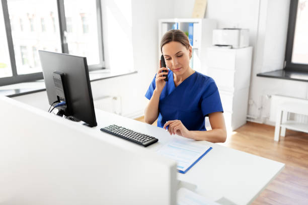 istock doctor with computer calling on phone at hospital 1369120189