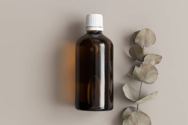 istock Pharmaceutical bottle mockup with an eucalyptus on the beige background. 1369120264