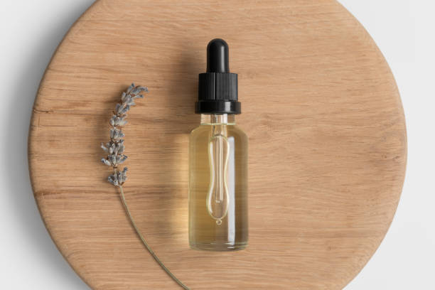 istock Dropper bottle mockup with lavender on the wooden background. 1369120287