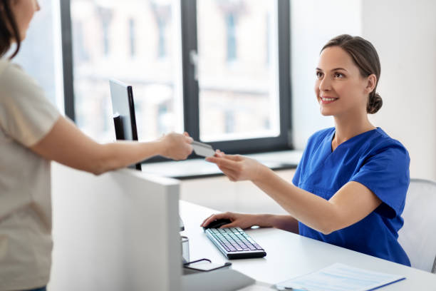 doctor and patient with credit card at hospital stock photo
