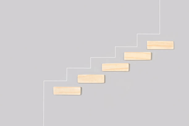 istock Square wooden cubes stair-shaped on a gray background 1369120972