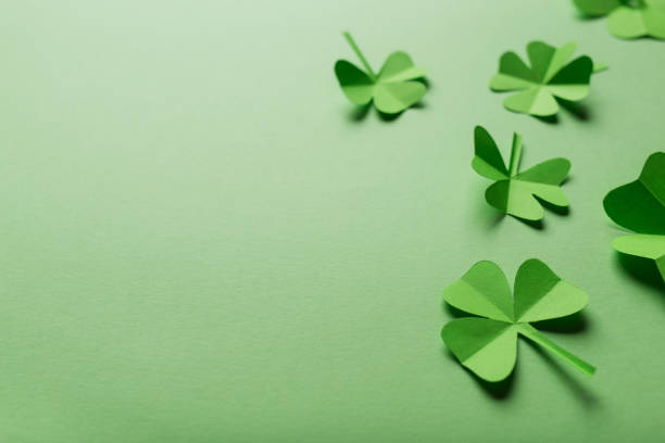 istock St. patrick's day. green background with clover leaves: shamrocks . copy space. Paper craft 1369121049