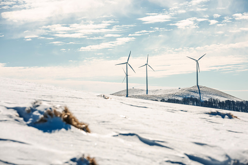 Wind power sustainable resource  in the mountains. Eolic turbines for wind power industry