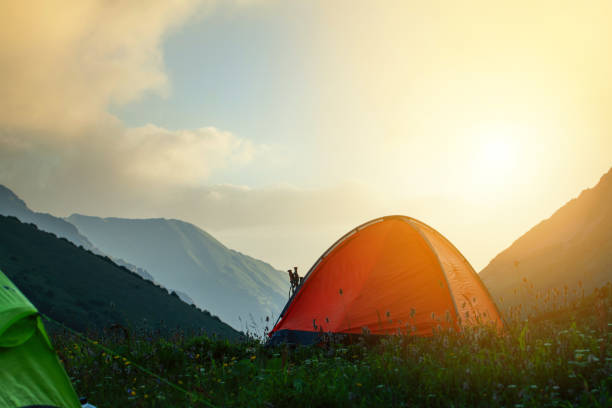 istock Orange tent in the mountains at sunset 1369124029
