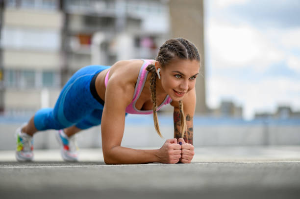 istock Attractive young woman in a plank position while training outside 1369125117