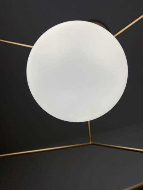 istock White round ceiling lamp with gold metal frame. 1369127253