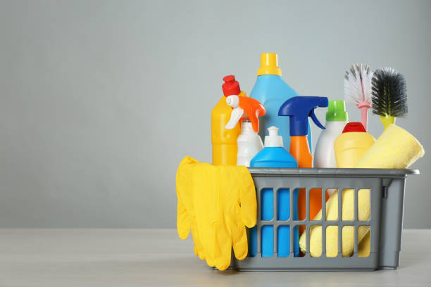 istock Basket with different cleaning products and supplies on light table. Space for text 1369127693