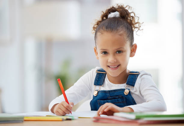 Shot of a little girl doing homework at home I love doing homework student desk stock pictures, royalty-free photos & images