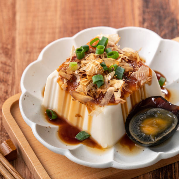 Delicious Chilled tofu and century egg with soy sauce and bonito flakes.