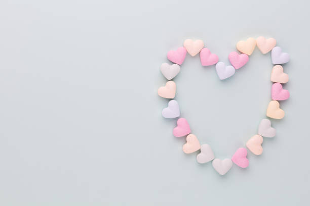 istock Composition with candy hearts on pastel blue background. 1369128173