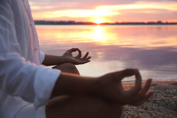 istock Man near river at sunset, closeup. Nature healing power 1369129521