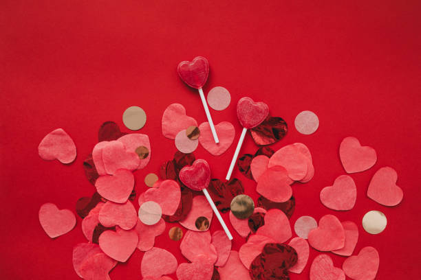 istock Heart shaped confetti on red background. Valentine's Day celebration. 1369131183