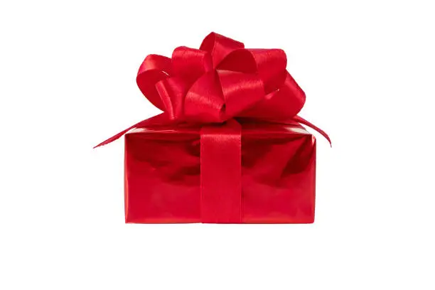 Red gift box with satin ribbon bow side view isolated on white. Holidays present.