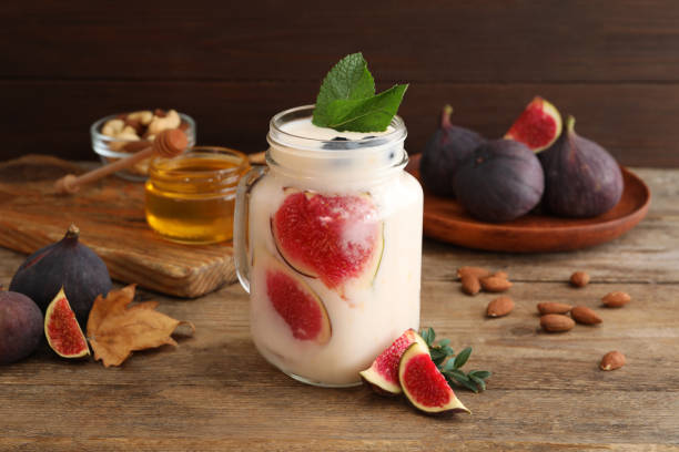 istock Delicious fig smoothie in mason jar on wooden table 1369132738