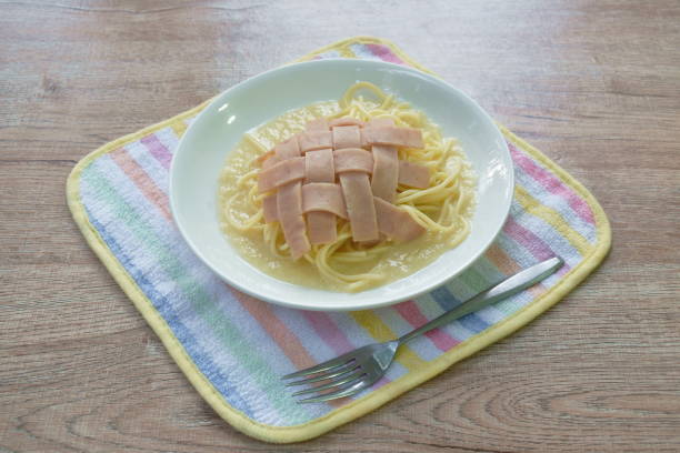 spaghetti white cream sauce topping slice ham pork stock photo