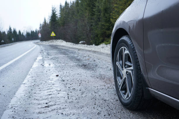 istock Car on a winter road in the forest. Road Trip Concept. 1369135497