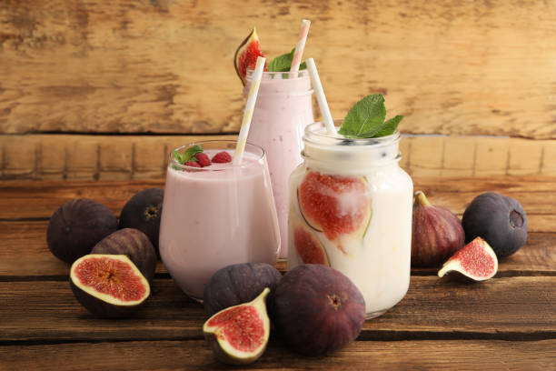 istock Delicious fig smoothies in glassware on wooden table 1369136590