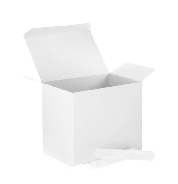 istock Open box and pieces of chalk on white background 1369136639