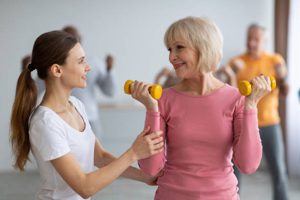 istock Fitness instructor assisting multiracial group of elderly people 1369138754