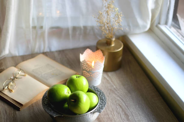 istock Green Apples, Book and Candle 1369138862