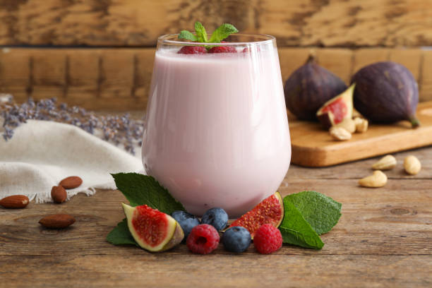 istock Delicious fig smoothie in glass on wooden table 1369139427