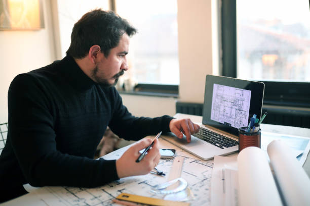 istock Modern Architect Businessman Produces Project in Design Office 1369139820