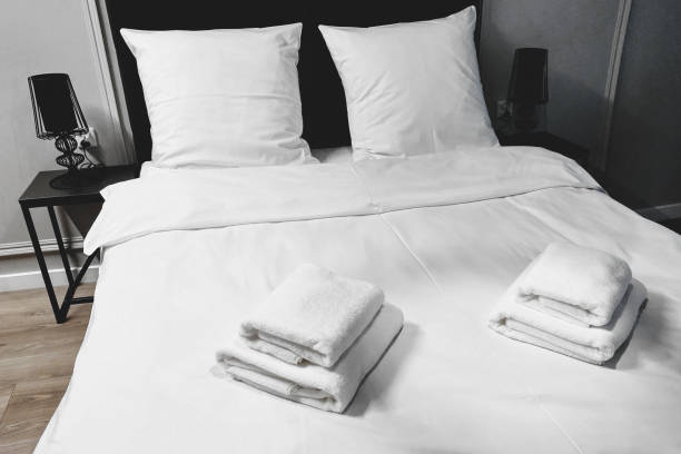 istock White towel on bed decoration in bedroom interior. 1369140671