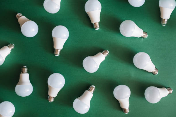 istock Full frame shot of light bulbs against green background. 1369140962