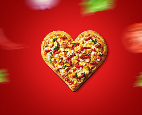 Valentine Day pizza or restaurant concept. love shape pizza isolated on red background concept of valentine day. love food- pizza day