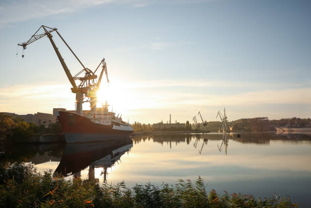 istock Big cranes and vessel at shipyard on sunny day 1369141176