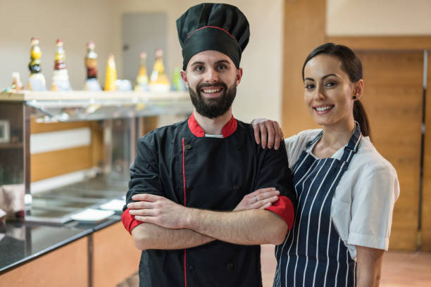 istock Young chefs welcoming quests at the restaurant 1369143211