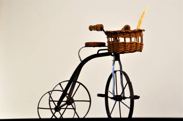 A beautiful metal bike with basket decorating furniture in the house